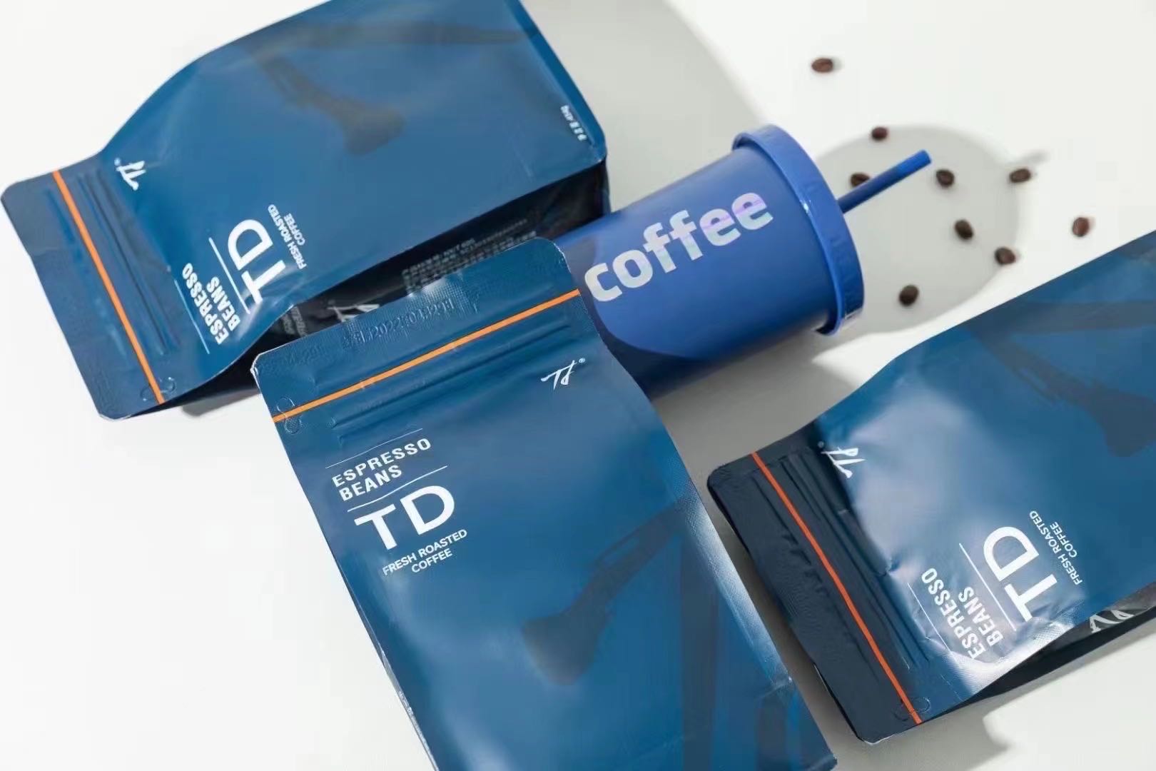 Real custom blue TD coffee pouches with coordinated typography and orange line details